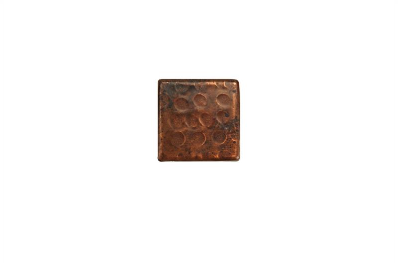 A beautiful metal tile made from copper featuring a hammered look